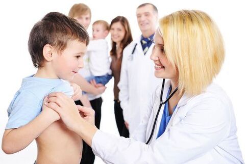 doctor examines a child with worms